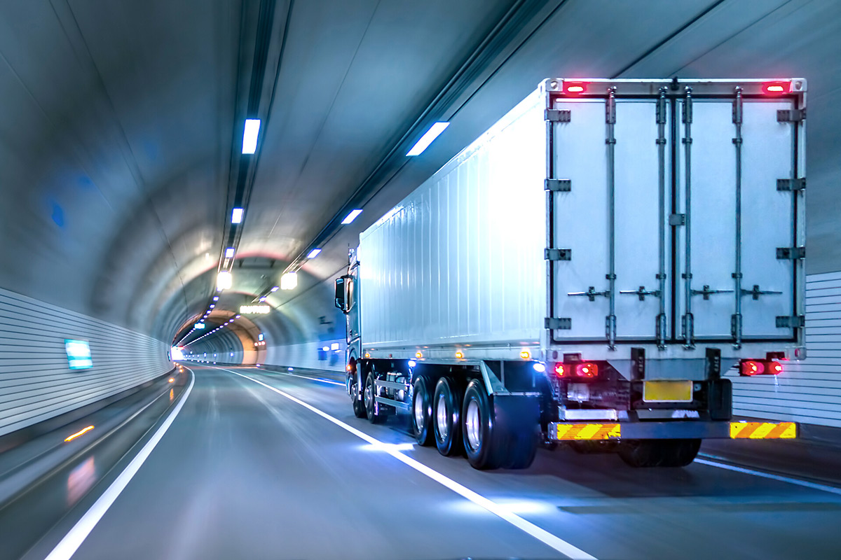 Truck transporting goods trough a tunnel.