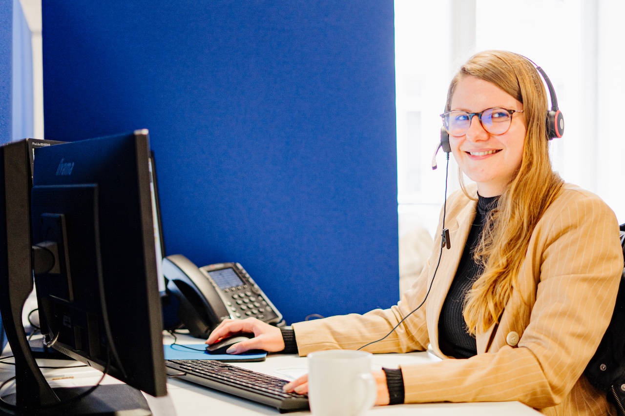 Julie portant des écouteurs à son poste de service clientèle à Nantes.