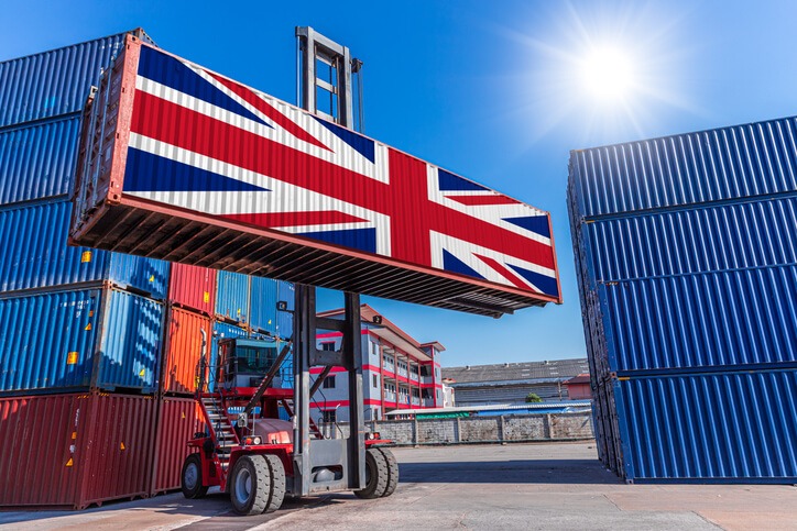 Handelsabkommen zwischen der EU und Australien bringt Vorteile für Importeure/Exporteure. Bild zeigt einen Stacker mit einem Container mit australischer Flagge vor blauem Himmel.